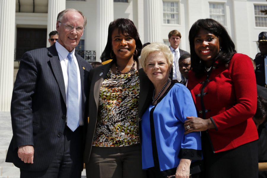 Governor Robert Bentley, Dr. Bernice King, Peggy Wallace Kennedy, and Congresswoman Terri Sewell stand together in front of a crowd of people gathered at the steps of the Alabama State Capitol after a march from Selma, Ala., Wednesday, March 25, 2015, in  Montgomery, Ala.  The daughters of Martin Luther King Jr. and former Alabama Gov. George Wallace, shared a stage on the steps of the Alabama Capitol on Wednesday to mark the 50th anniversary of the 1965 Selma-to-Montgomery voting rights march.   (AP Photo/Butch Dill)
