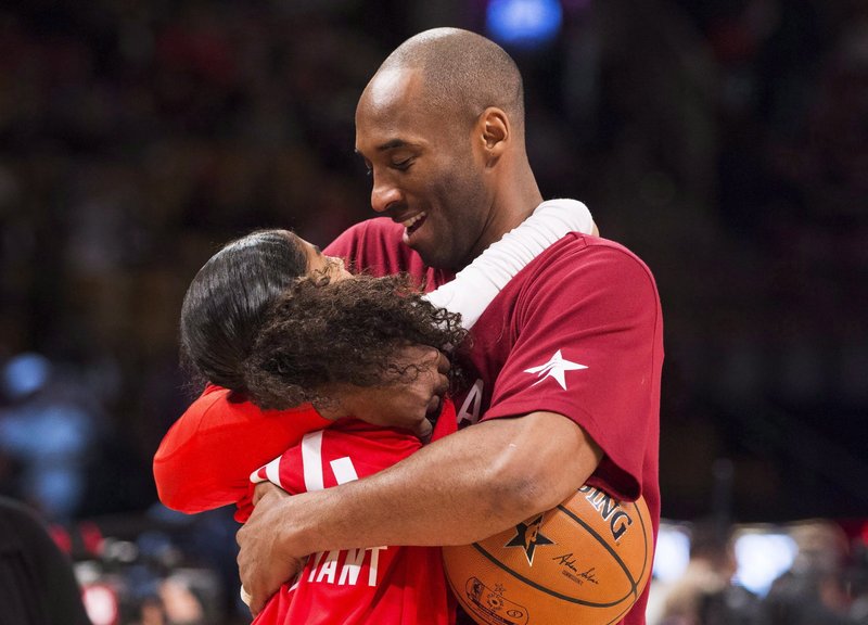 In this Feb. 14, 2016, file photo, Los Angeles Lakers Kobe Bryant (24) hugs his daughter Gianna on the court in warm-ups before first half NBA All-Star Game basketball action in Toronto. Bryant, his 13-year-old daughter, Gianna, and several others are dead after their helicopter went down in Southern California on Sunday, Jan. 26, 2020. 