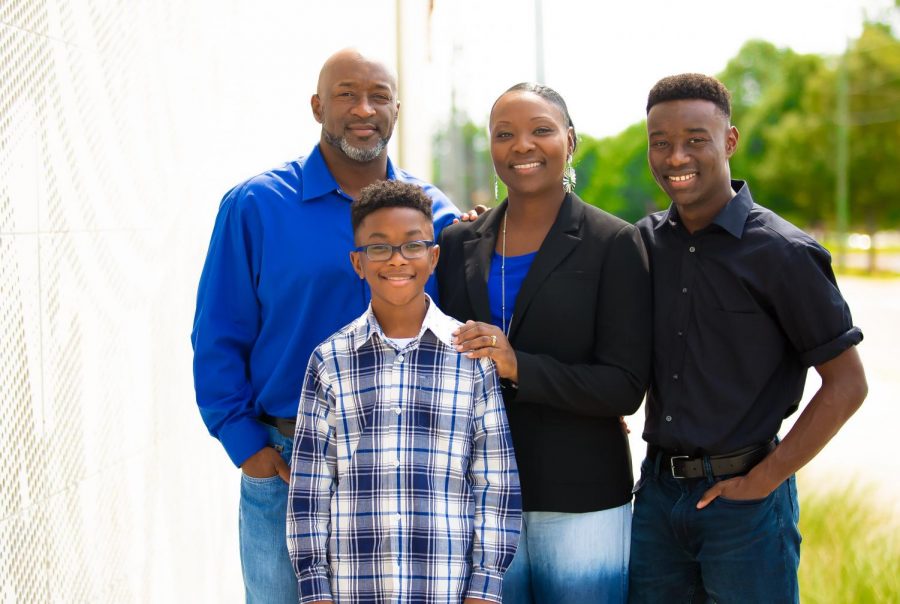 Angela Harris Hampton takes a minute to pose with her family in front of the newly constructed Interpretive Center on the campus. (L-R) Edwin Hampton, Braydon and Bryce.