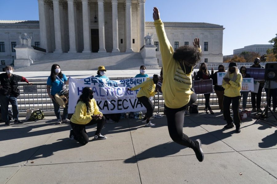 The dance group The Peoples Dancers, perform in front of the U.S. Supreme Court as arguments are heard about the Affordable Care Act, Tuesday, Nov. 10, 2020, in Washington. (AP Photo/Alex Brandon)