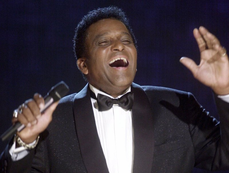CORRECTS FIRST NAME TO CHARLEY, INSTEAD OF CHARLIE FILE - In this Oct. 4, 2000, file photo, Charley Pride performs during his induction into the Country Music Hall of Fame at the Country Music Association Awards show at the Grand Ole Opry House in Nashville, Tenn. Pride, the son of sharecroppers in Mississippi and became one of country music’s biggest stars and the first Black member of the Country Music Hall of Fame, has died at age 86. Pride died Saturday, Dec. 12, 2020, in Dallas of complications from Covid-19, according to Jeremy Westby of the public relations firm 2911 Media. (AP Photo/Charlie Neibergall, File)