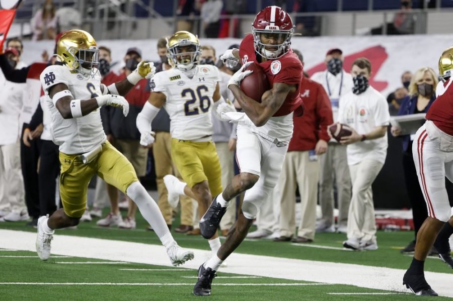 Alabama wide receiver DeVonta Smith (6) gets past Notre Dame linebacker Jeremiah Owusu-Koramoah (6) and cornerback Clarence Lewis (26) on his way to the end zone for a touchdown in the first half of the Rose Bowl NCAA college football game in Arlington, Texas, Friday, Jan. 1, 2021. (AP Photo/Michael Ainsworth)