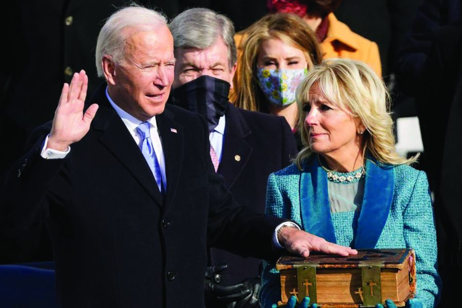 Biden takes the helm, appeals for unity to take on crises