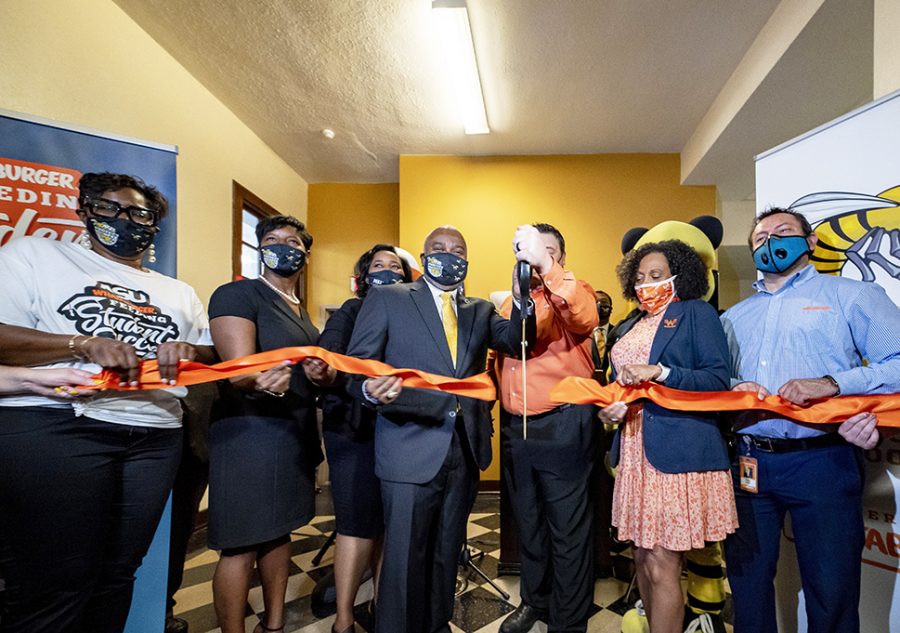 Whataburger+rep%2C+trustee%2C+university+administrators%2C+staff+and+faculty+cut+the+ribbon+during+the+opening+of+the+Resource+Room