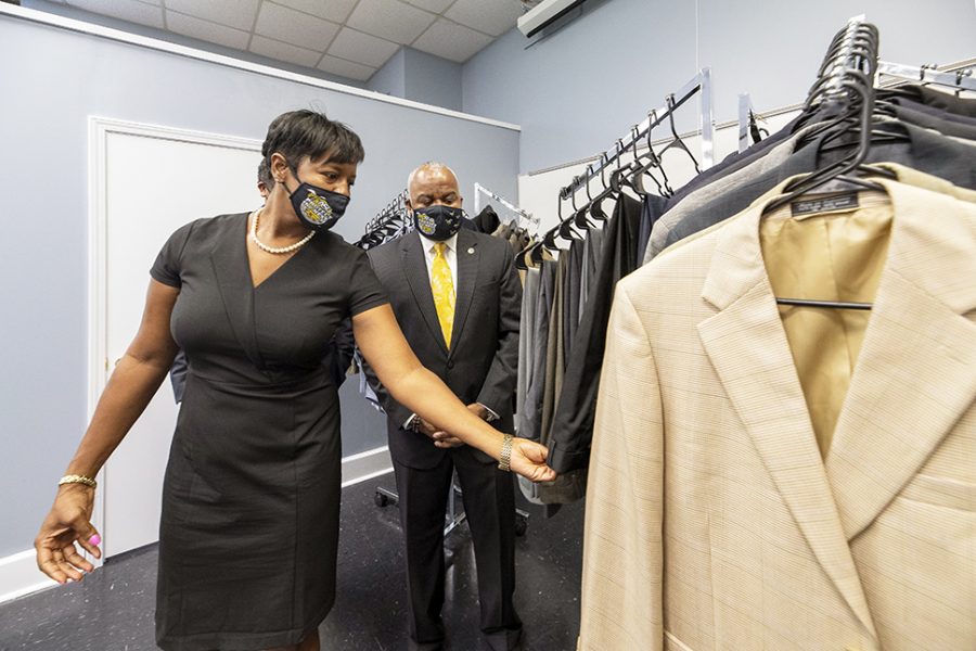 University Trustee Tiffany McCord and President Quinton T. 
Ross, Jr., Ed.D., check out the clothing donation for student use 
that will be held in the Whataburger Resource Room