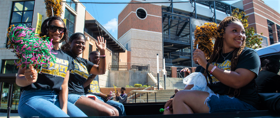 During the first historic Homecoming campus parade, the SGA executive officers boarded the back of a truck as they waved to the crowd as they passed the Alabama State University community.
