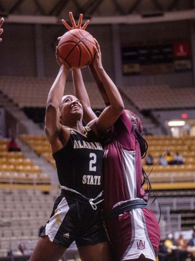 During the highly anticipated match between Alabama State University and Alabama Agricultural and Mechanical University, graduate student Kailya Jackson goes up and through the outstretched arms of a Bulldogs defender as they go on to win the contest 74-69.