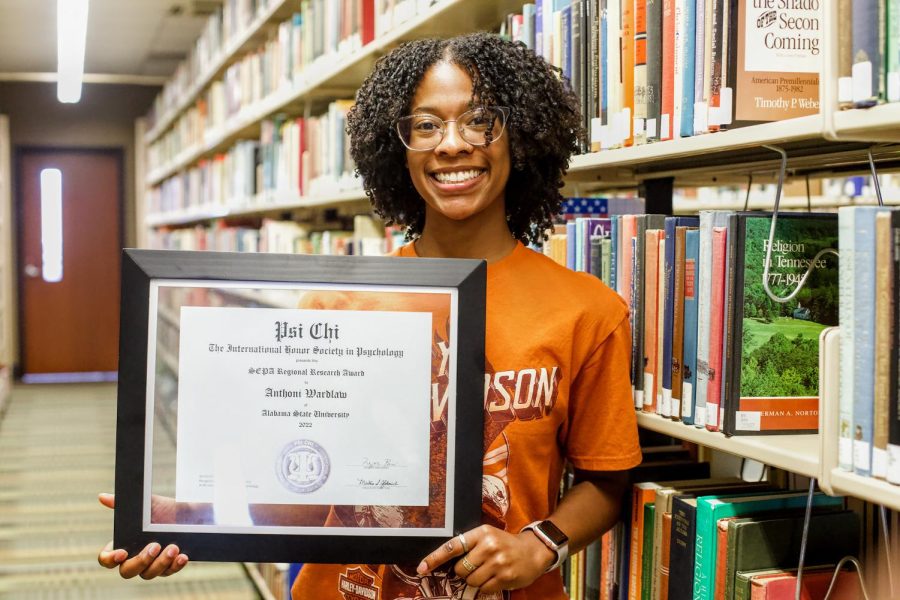 Senior Anthoni Anna Wardlaw smiles radiantly as she displays her SEPA Regional Research Award that was given to her by the International Honor Society in Psychology during a recent trip to South Carolina, where she presented her research of four years.