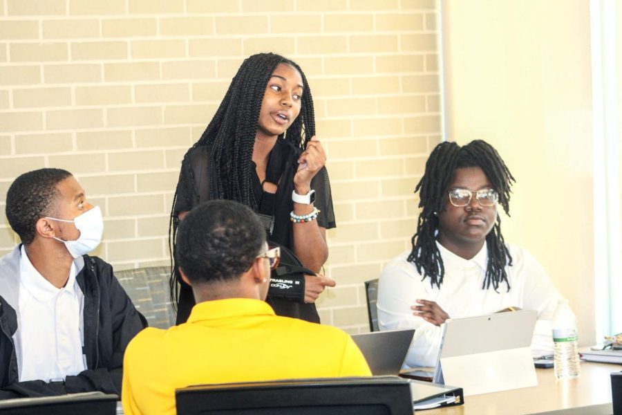 Sen. Dasia Newell (standing) who represents the College of Health Sciences argued her point during the icebreaker sessions of the workshop.  Senate President Trint Martinez formed two groups of senators and each group had to defend their position on a topic.