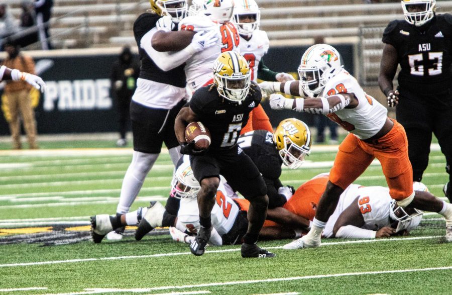 During the Alabama State University vs. Florida Agricultural and Mechanical University football game, graduate running back Santo Dunn escapes Rattler defenders en route to a first down.