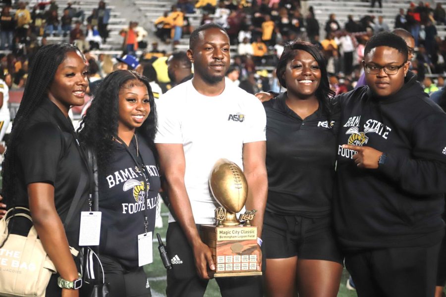 After an exciting, invigorating and thrilling win by the Alabama State University Hornets during the fourth quarter, students, alumni and fans stood in line to take photos with the Magic City Classic trophy.
