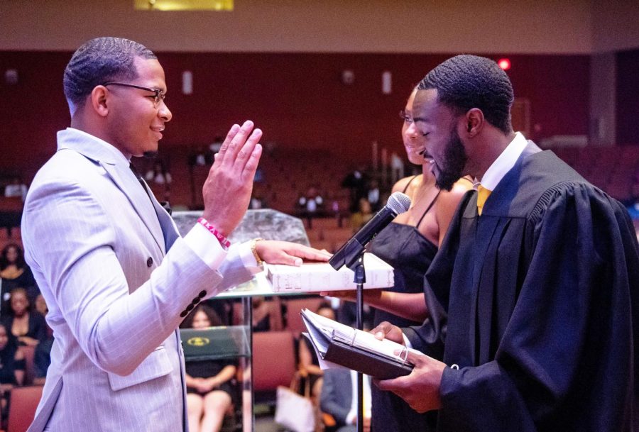 SGA Executive President Dylan Stallworth listens carefully as the Student Supreme Court Chief Justice Edward Brown administers the Oath of Affirmation during the formal investiture of elected officers.