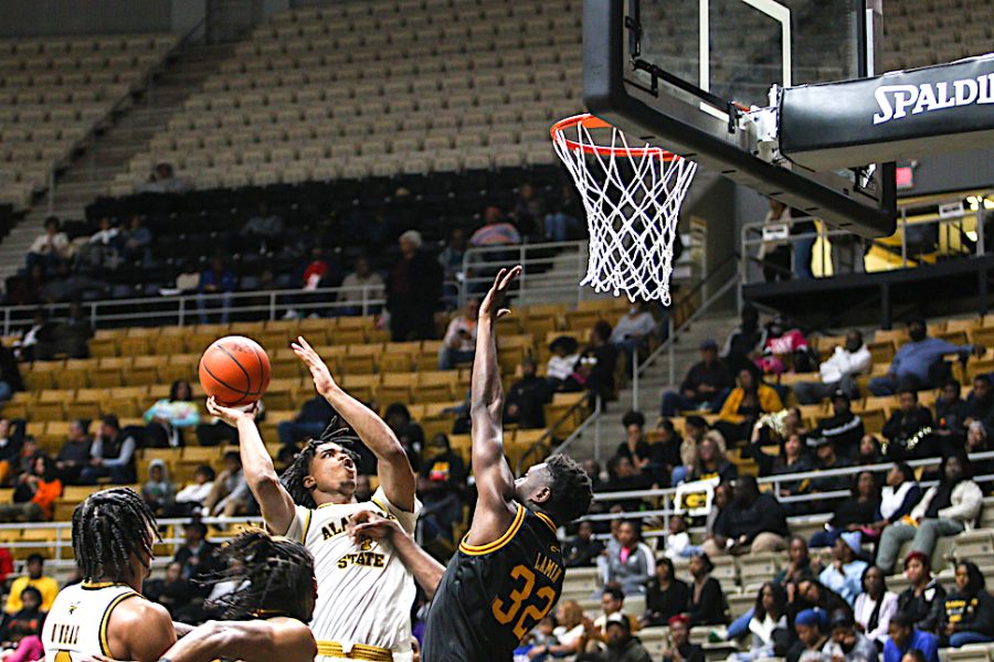 Rising up over the out stretched hands of a Grambling State University Tiger defender, Hornet junior forward Duane Posey attempts a layup after penetrating the paint.