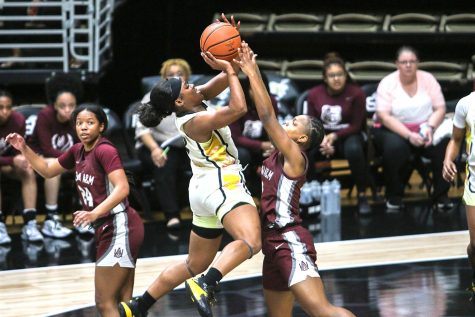 Hornet senior guard Jayla Crawford manuevers her way into the paint and pulls up for a heavily contested jumper at the top of the key in the Hornets’ big win over the Alabama A & M Bulldogs.