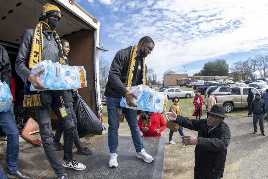 Alabama State University student leaders are taking the initiative to assist in the unloading of relief supplies that were purchased by several civic organizations and citizens in Montgomery.  Pictured are Isaiah Brunson, Reginald Flowers and Dylan Stallworth unloading packaged bottle water and other supplies for residents who were severely affected by the recent tornado that hit Selma on last week.