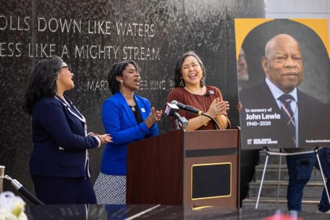 From left, U.S. Rep. Nikema Williams and the SPLC’s Tafeni English-Relf and Margaret Huang next to a portrait of John R. Lewis, who for many years led a delegation to the Memorial to mark the anniversary of the Bloody Sunday voting rights march. 