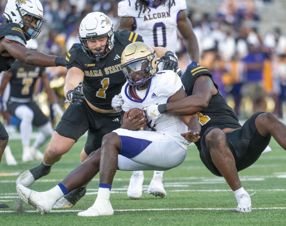 During the football game between the Alabama State University Hornets and the Alcorn State University Braves, Hornet linebacker Colton Adams assist with the tackle on Brave quarterback Aaron Allen.
