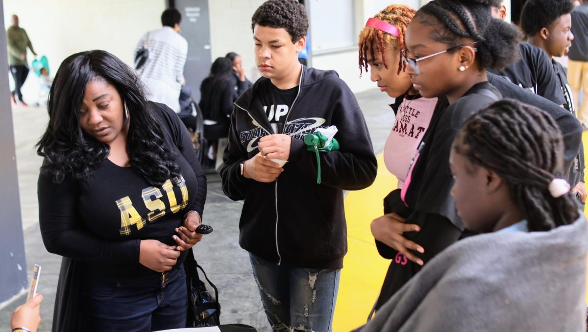 Former Miss Alabama State University Deanna Poe assists several prospective students from the Birmingham, Alabama area who are thinking about attending Alabama State University in the fall.