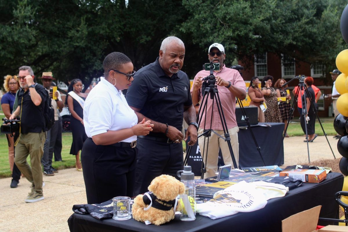 President Quinton T. Ross Jr., Ed.D. and Executive Director Shani Crayton review the many items that were brought by Hornet Nation to be placed into the Time Capsule that would open in 2074.