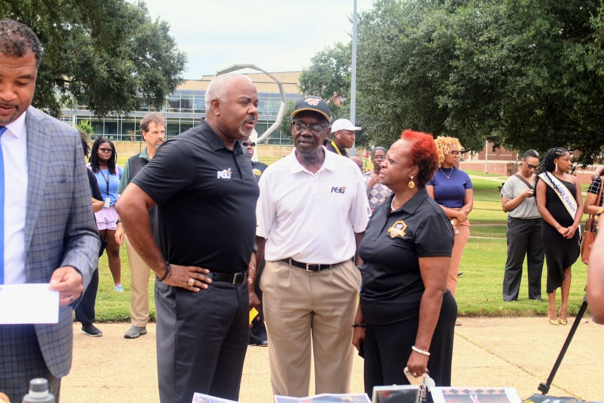 President Quinton T. Ross Jr., Ed.D., confers with two of the university’s longest serving faculty members, Coach Larry Watkins and Coach Barbara Williams, regarding the items that were placed in the time capsule back in 1974. 