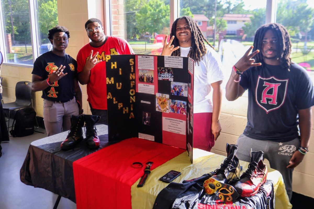 Members of Phi Mu Alpha Sinfonia is an American collegiate social fraternity for men with a special interest in music.  Picture above are members as well as their display table about the fraternity.