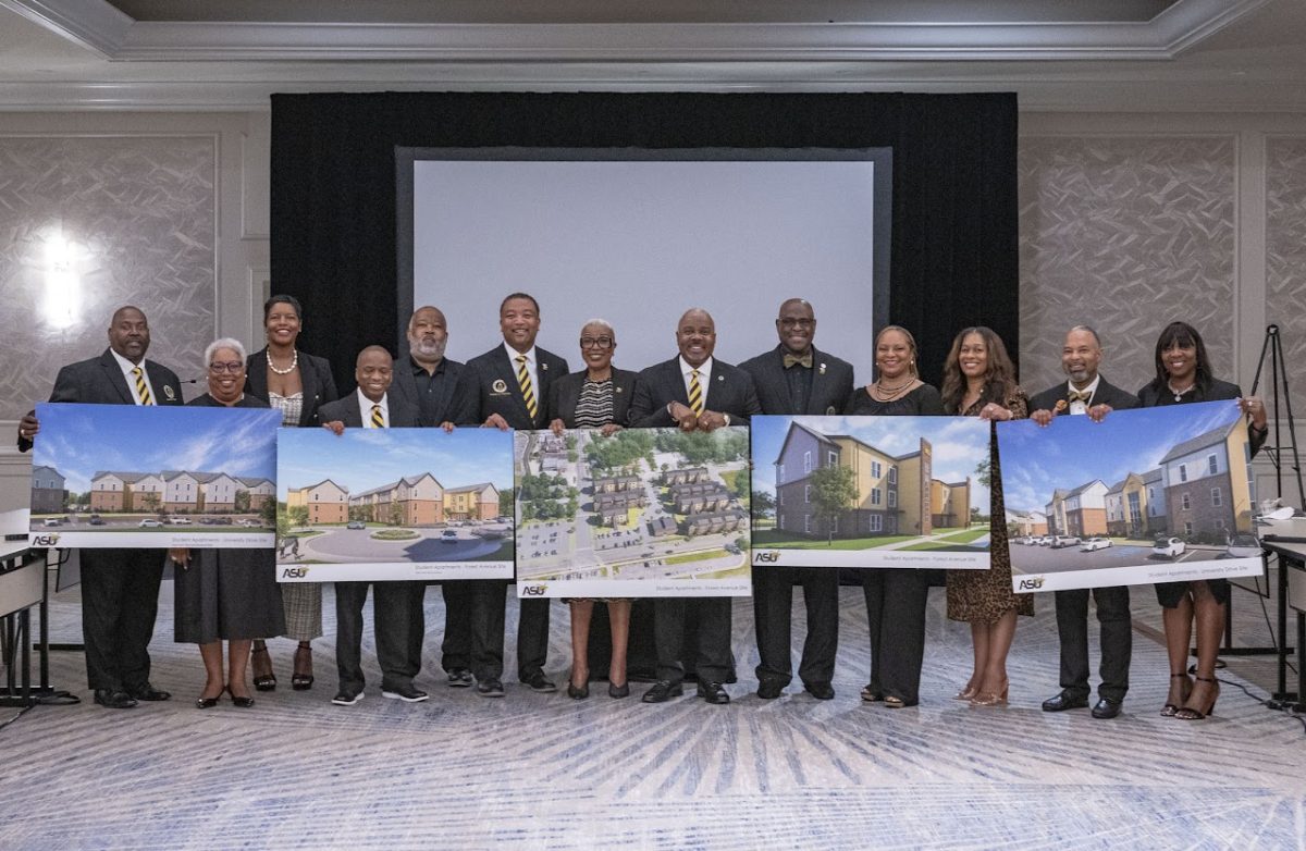 Members of the Alabama State University Board of Trustees as well as President Quinton T. Ross Jr., Ed.D., display renderings of the new residential apartments in which construction will soon begin for student housing.