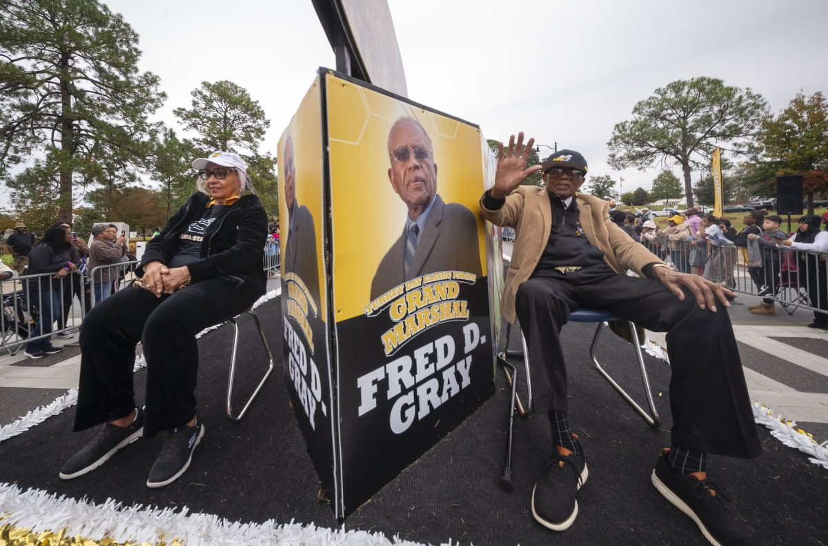 Noted civil rights attorney and most recognized for his work with the Montgomery Bus Boycott and Parade Marshall Fred Gray, Esquire, is joined by his wife as they wave to the parade onlookers during the 88th Turkey Day Classic parade.