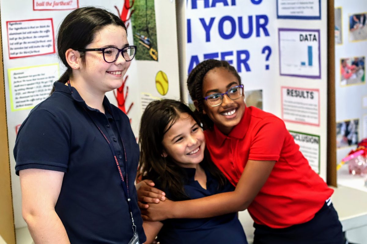 Some Montgomery Public School students embrace each other for their accomplishments as the judges walked around to view their individual science projects.