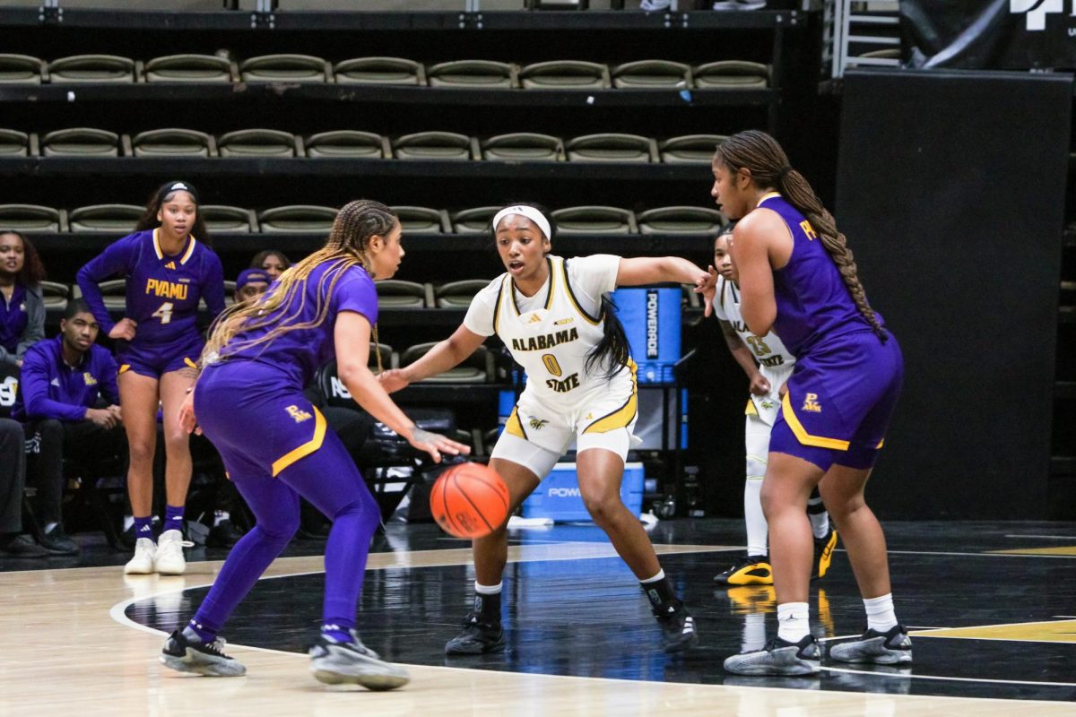 Alabama State University Hornets guard Amari Franklin plays defense against Prairie View Agricultural and Mechanical University Panthers guard Nyam Thornton as the offense set sup a screen.