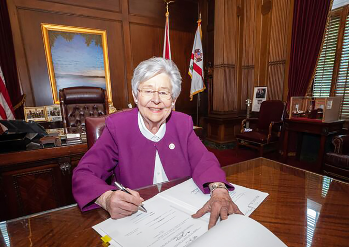 Gov. Kay Ivey signs an executive order for the U.S. flags to be raised for the presidential inauguration after President Biden ordered the flags to be lowered.